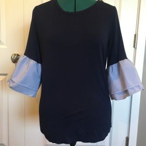 Cute navy blouse with striped sleeves.